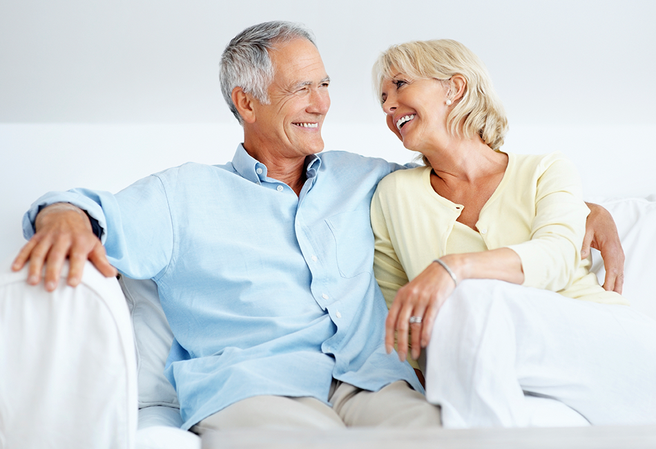 Couple on couch considering In-Retirement Loans