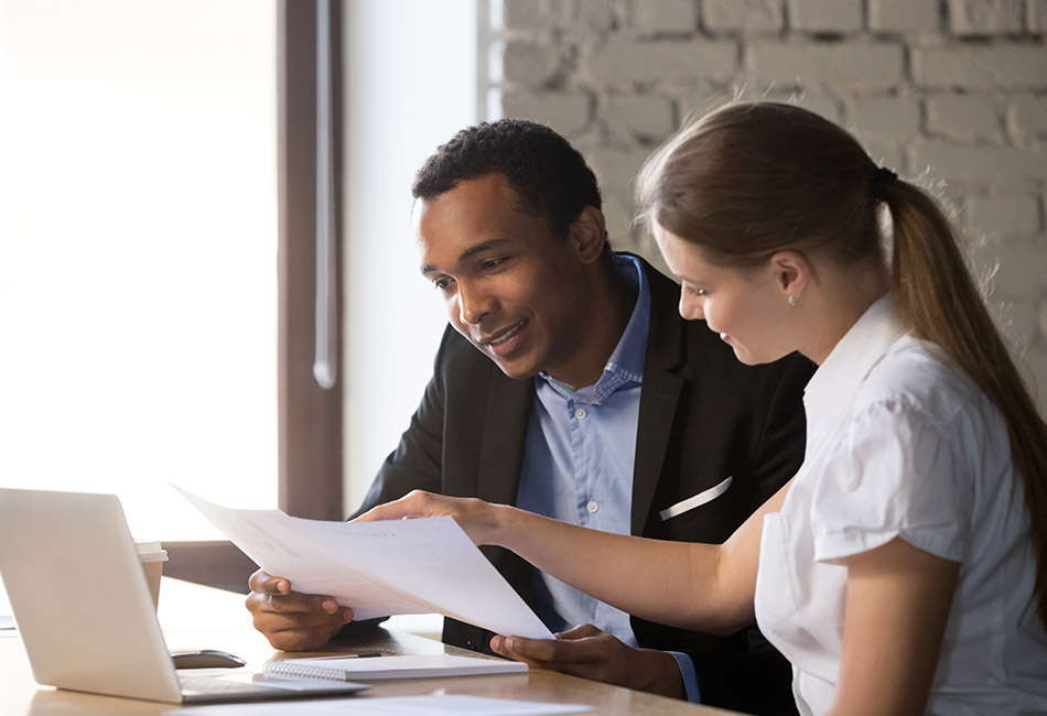 African American man and Caucasian woman reviewing document