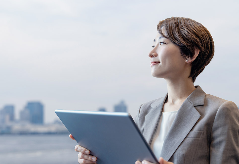 Businesswoman overlooking city with tablet