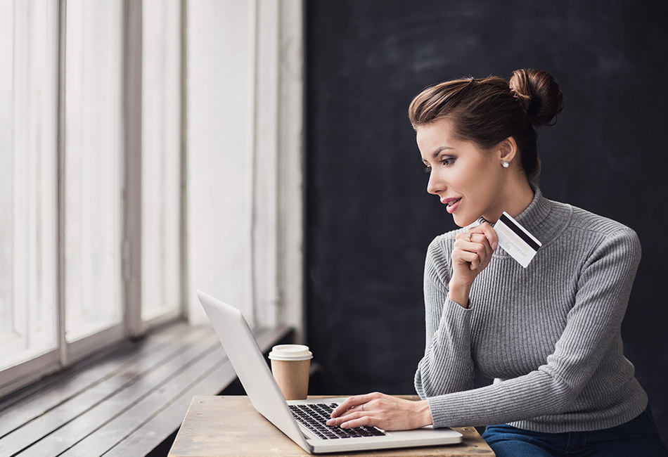 Caucasian woman with laptop and debit card