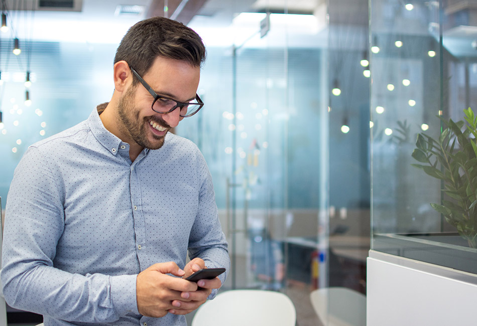 Caucasian businessman looking at cell phone