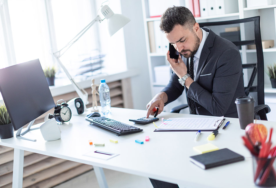 Businessman using calculator on phone