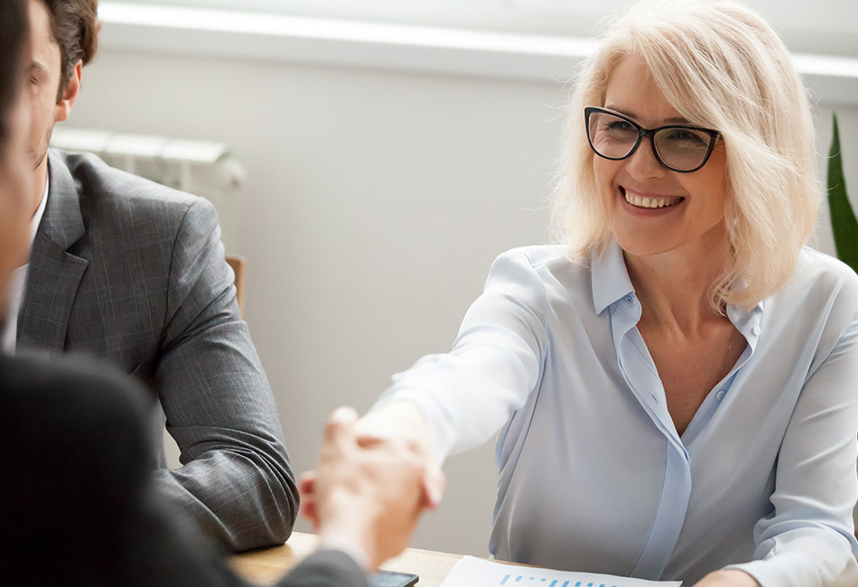 Caucasian woman shaking hands with man