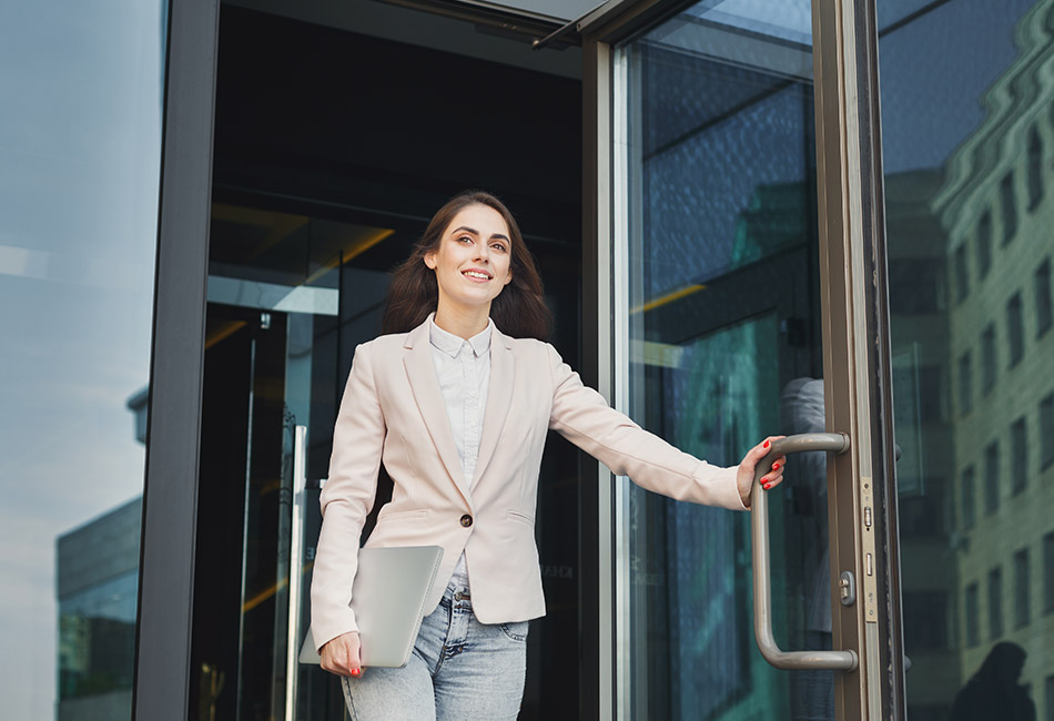 Caucasian woman walking out of office building