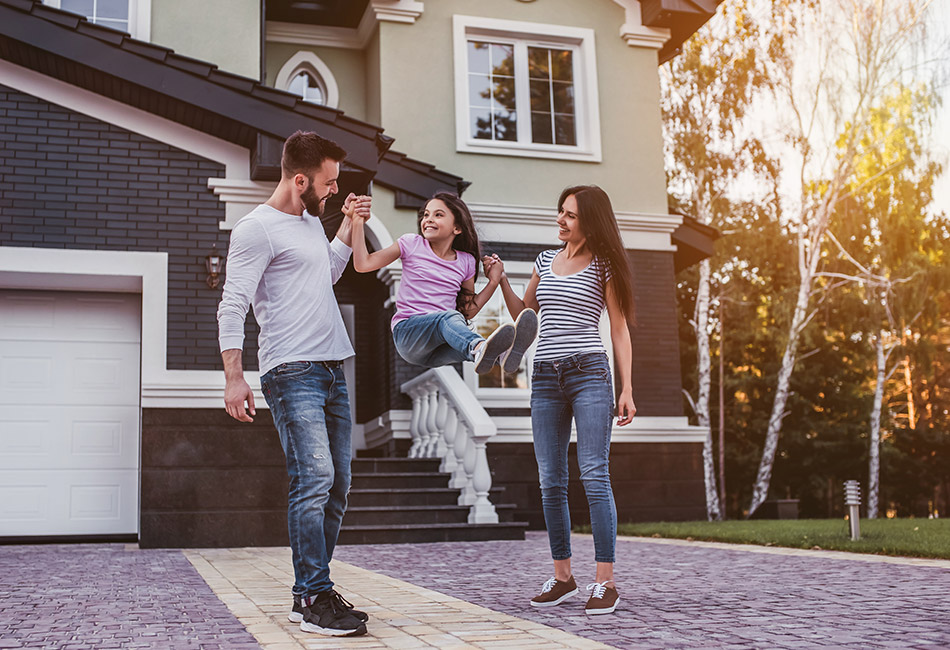 Parents playing with daughter outside of home