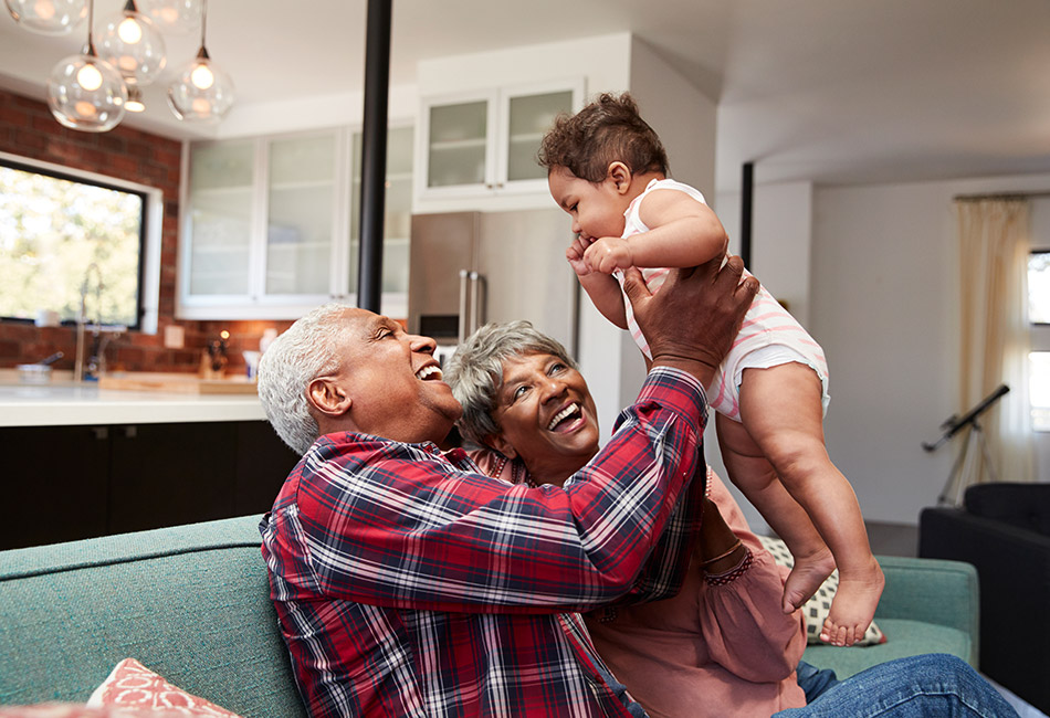 African American grandparents playing with granddaughter
