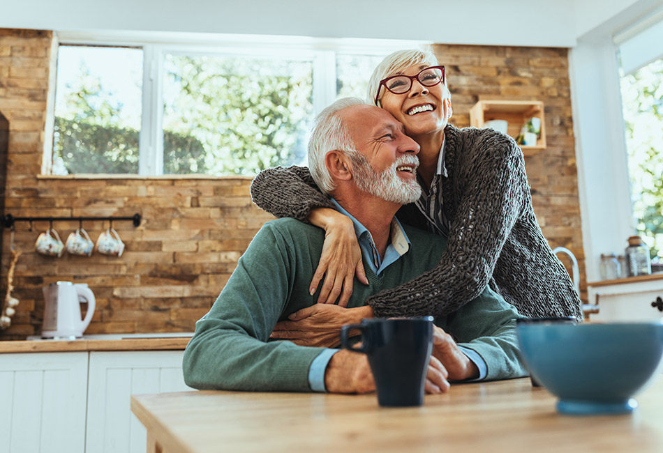 Older Caucasian couple in kitchen at home