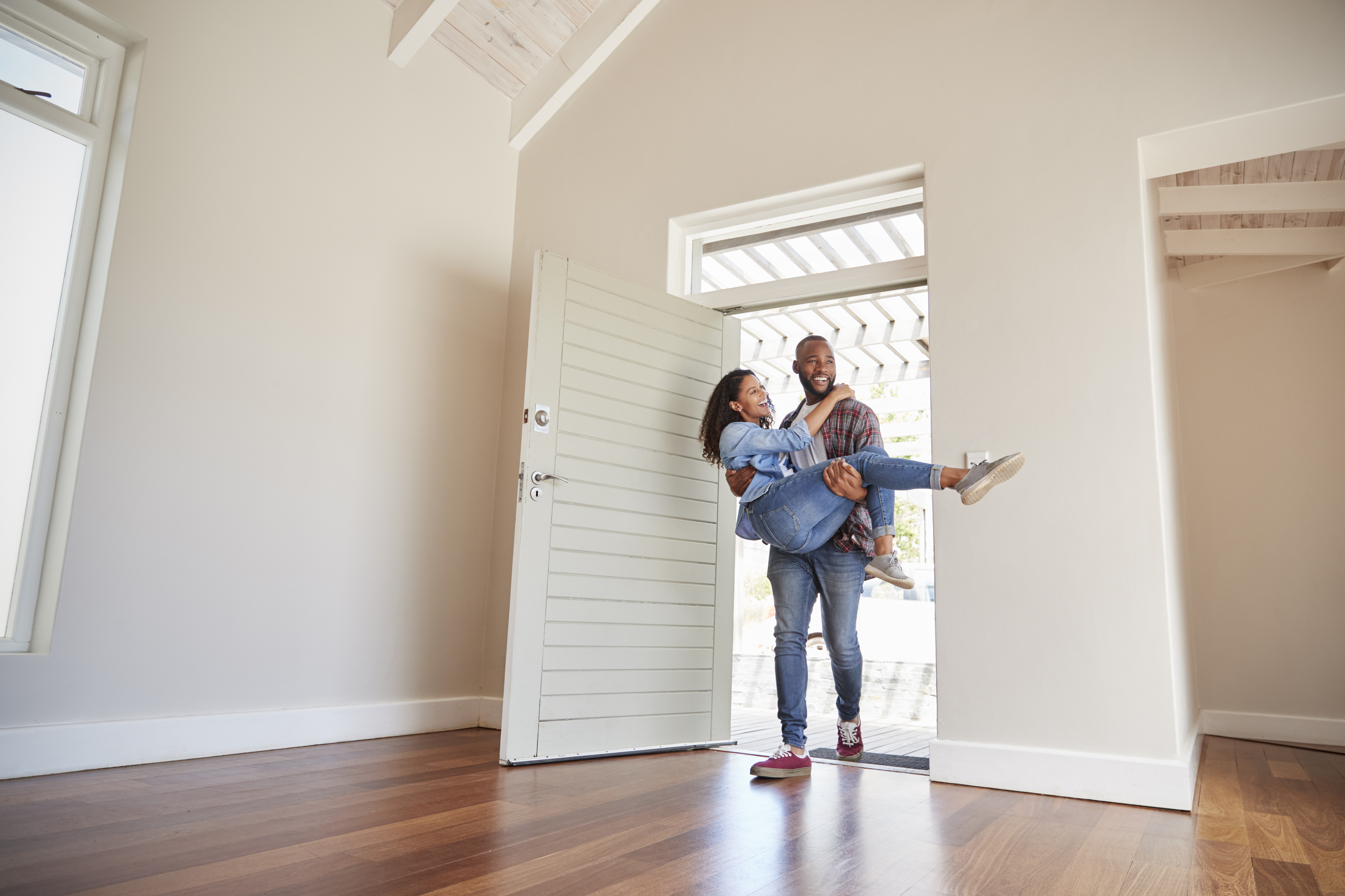 African American couple walking into first home