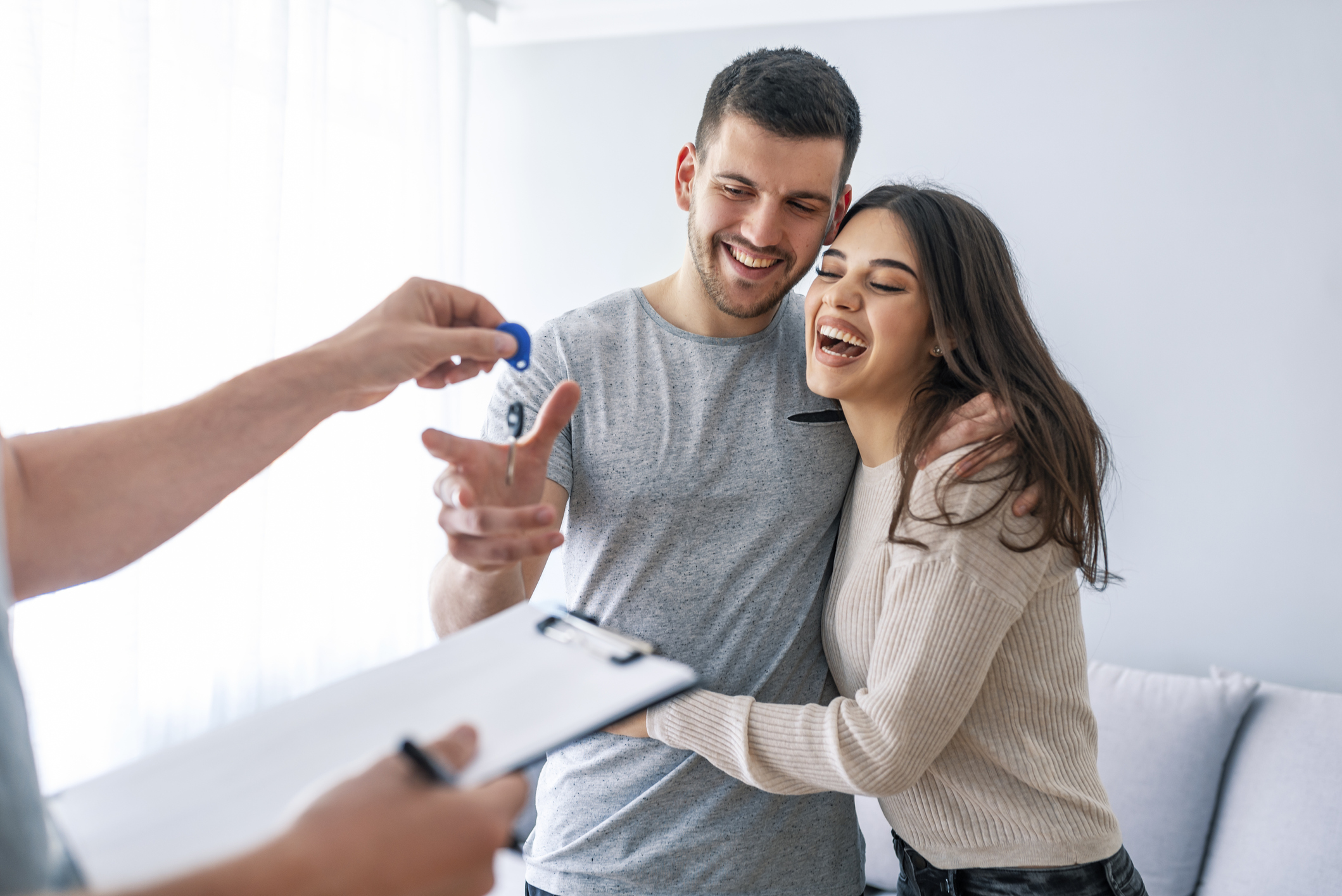 Young couple getting keys to new home