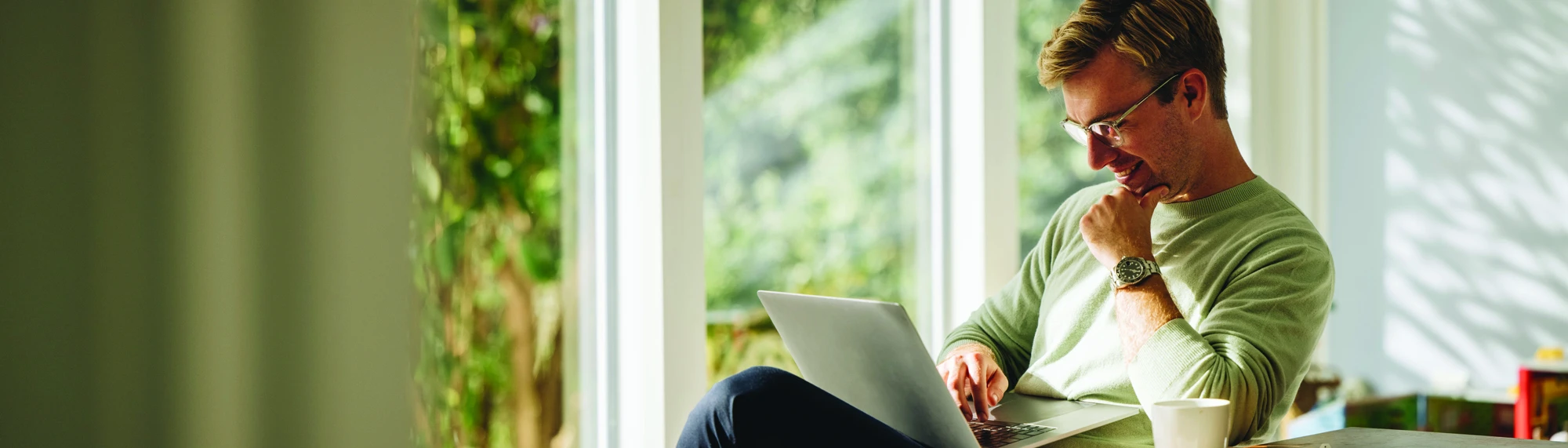 caucasian man on laptop at home