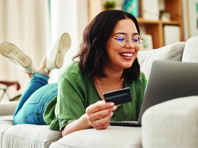 woman using debit card online shopping