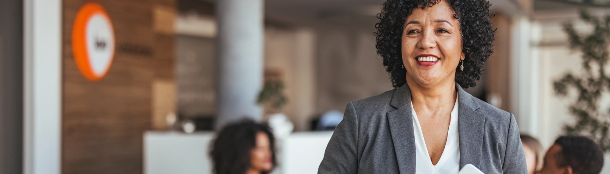 african american business woman standing with tablet