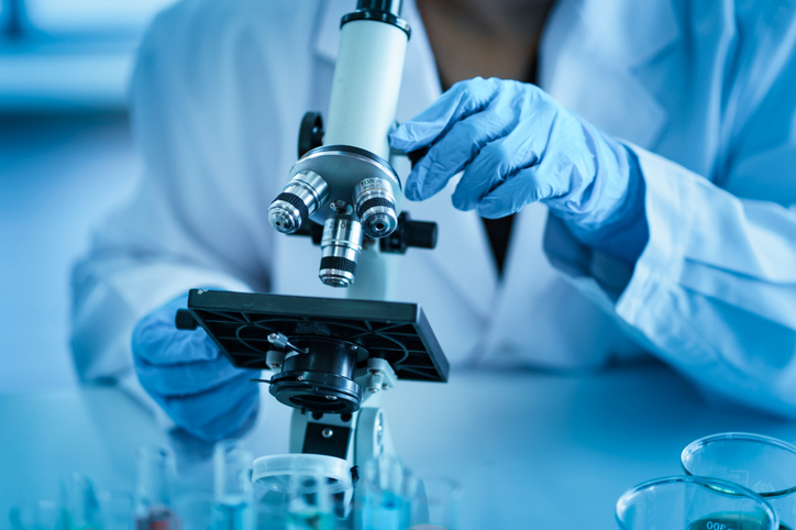 scientist using microscope