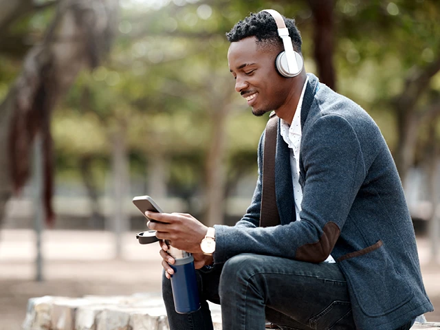 Man on phone with wireless headphones