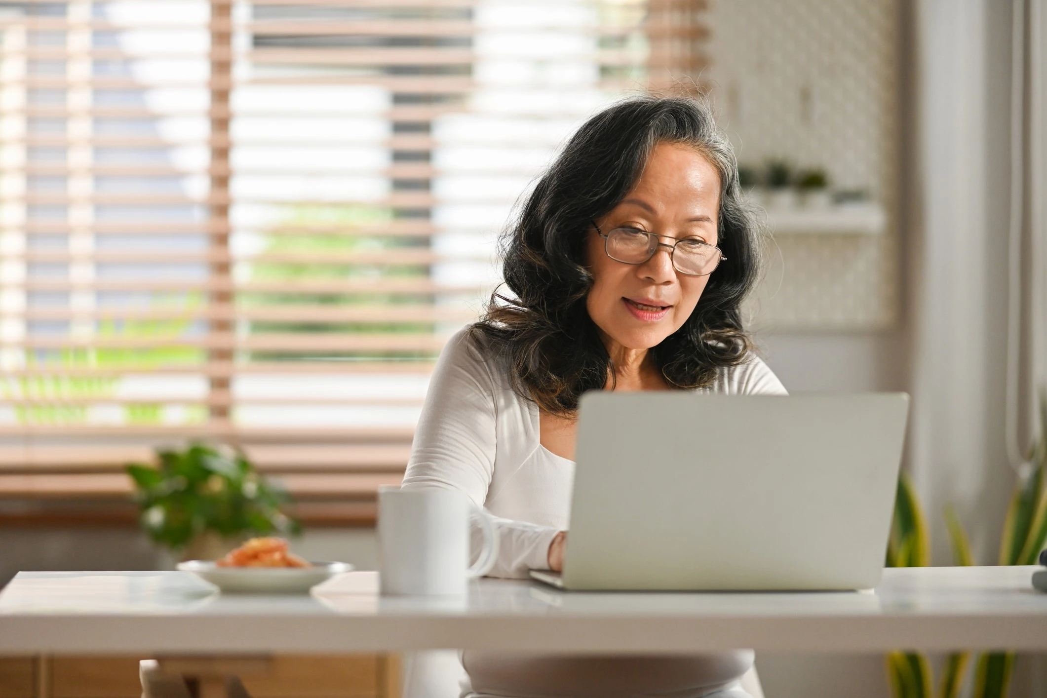 older asian woman on laptop