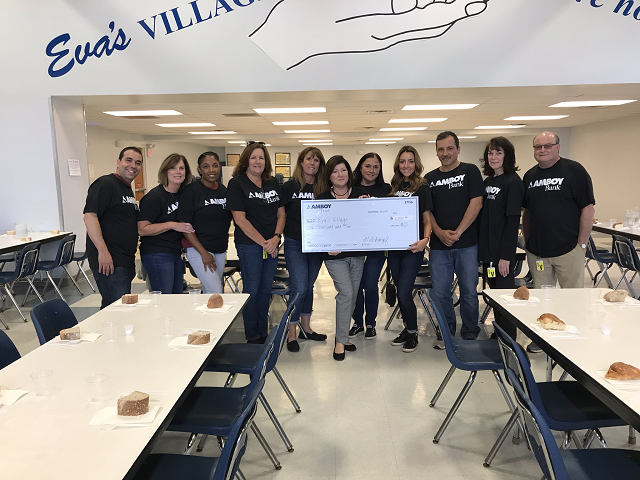 evasvillage2019.png Amboy Bank presents check at Eva's Village